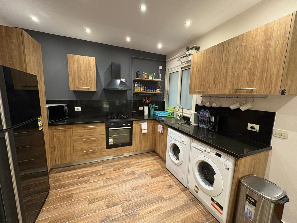 Fitted kitchen with oven, gas hob, microwave and fridge-freezer