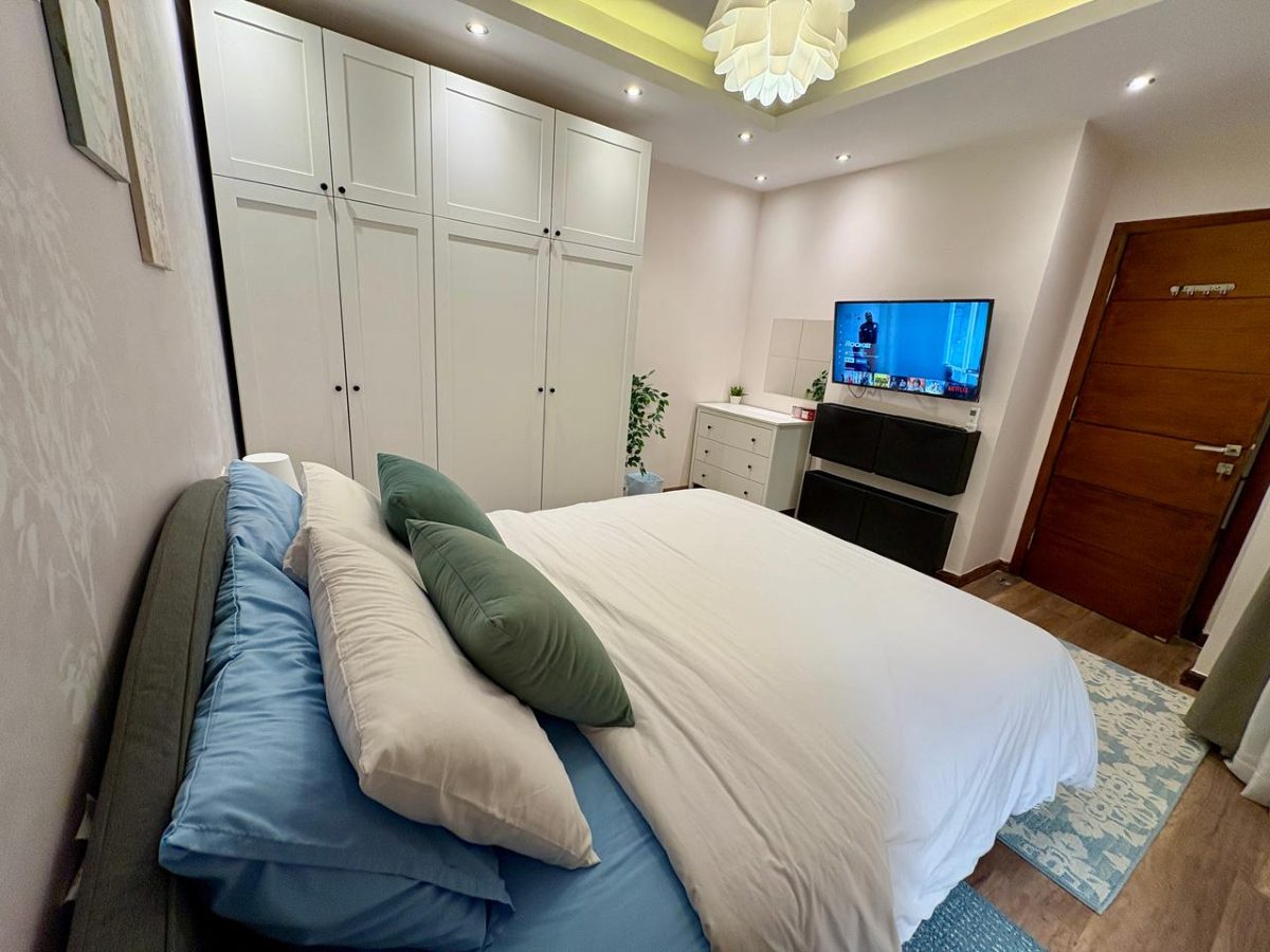 Bedroom wardrobe with a wall-mounted Smart TV