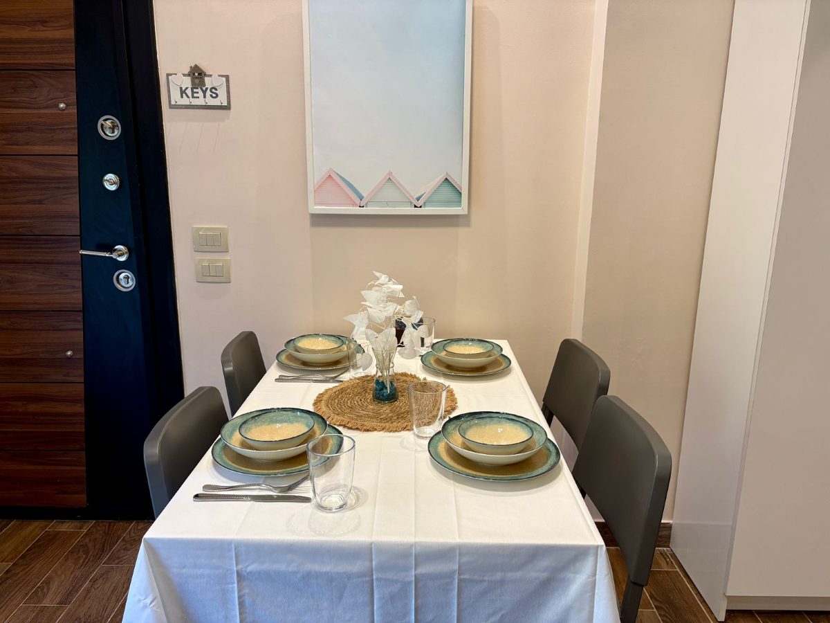 Dining table set beside the living-room window, usable as a desk