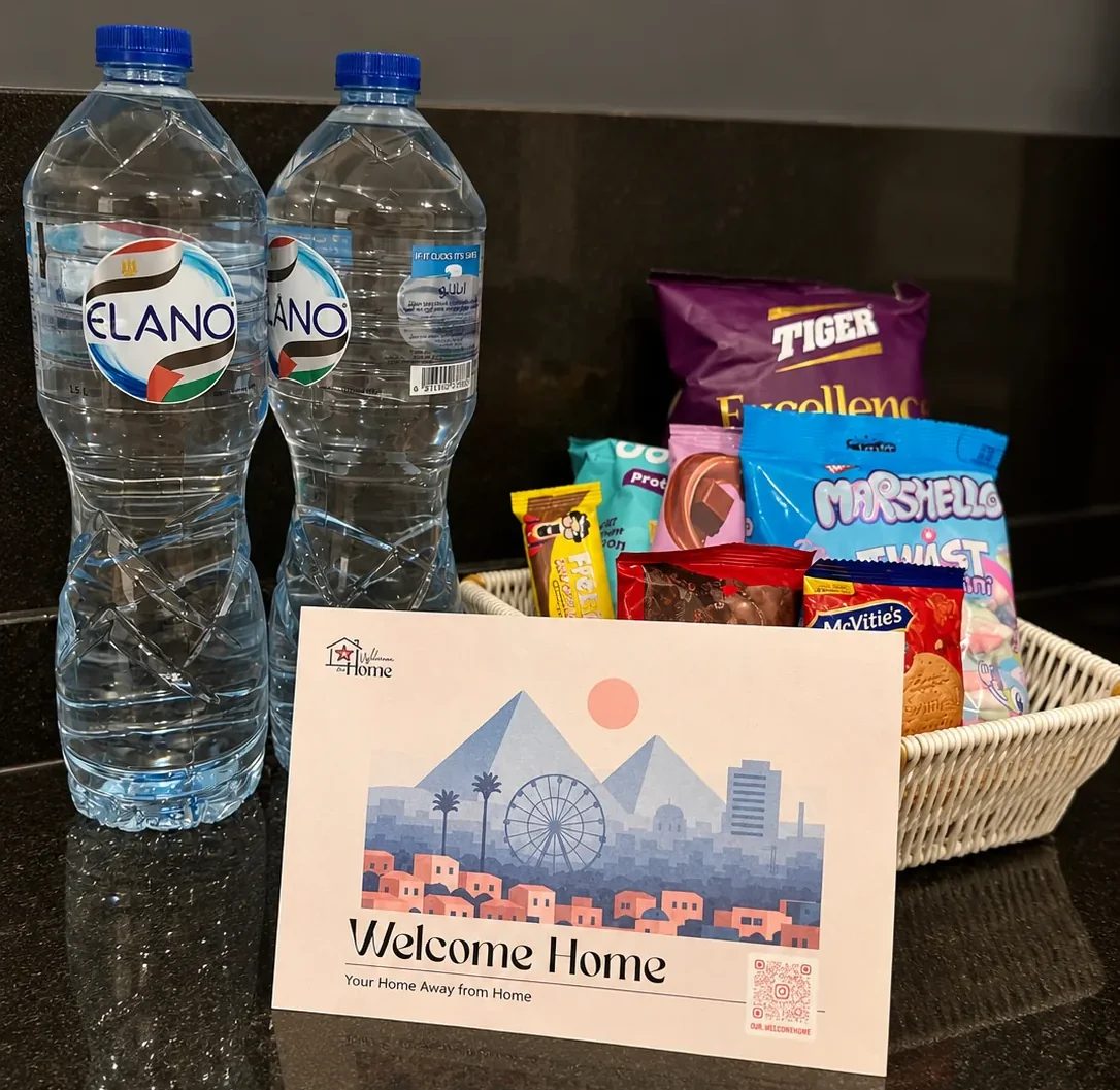 Welcome basket of snacks with two bottles of water and a greeting card