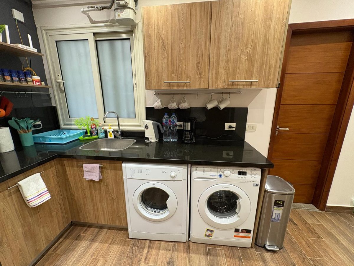 Washing machine and separate tumble dryer in the kitchen