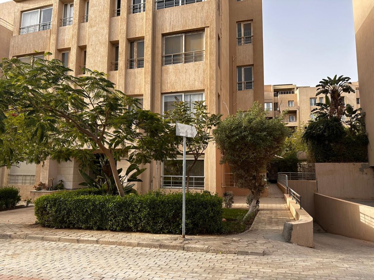 The residential building exterior and shared entrance approach within Karma Residence.