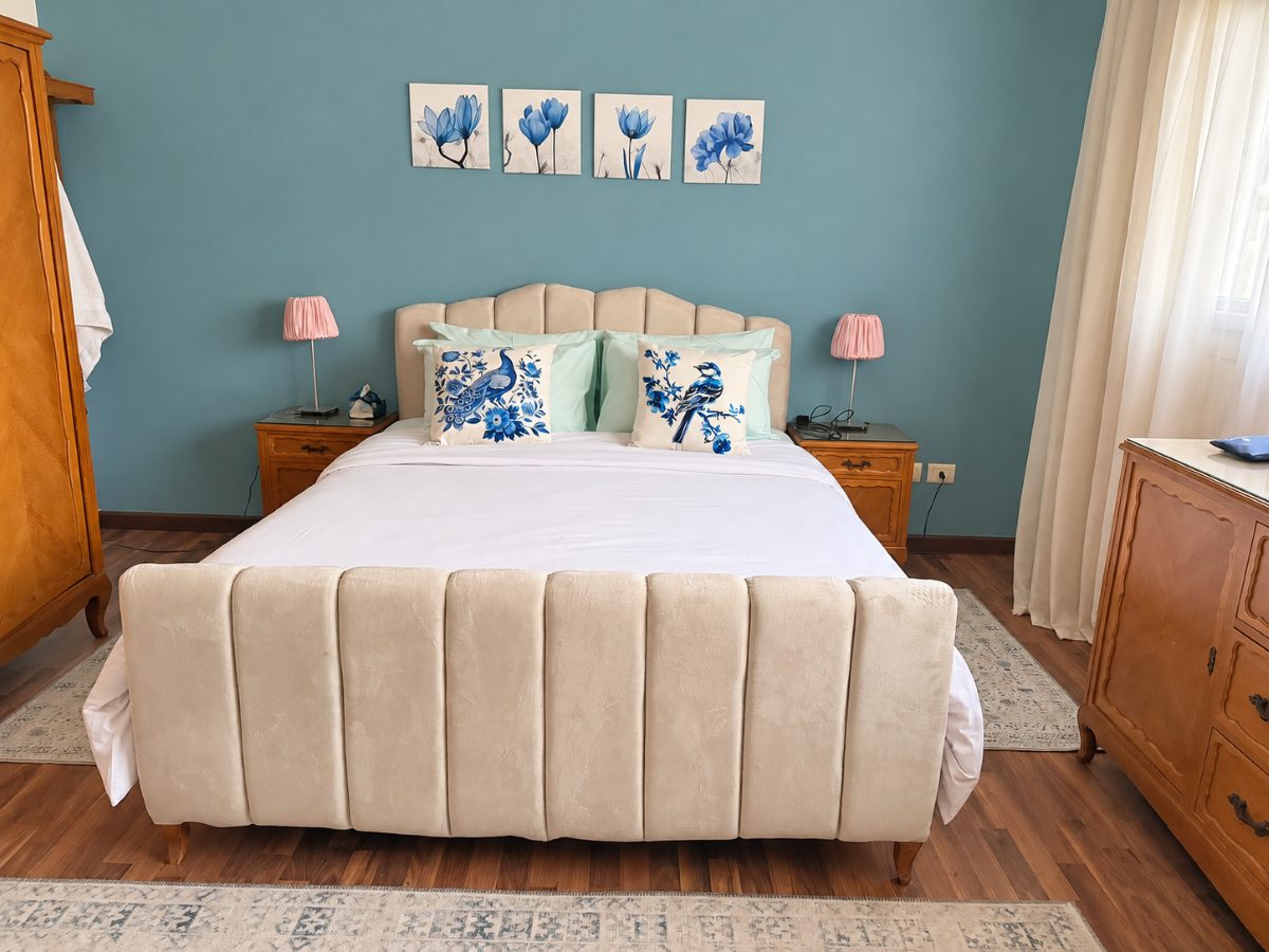 Main bedroom with a queen bed, bedside tables and soft natural light