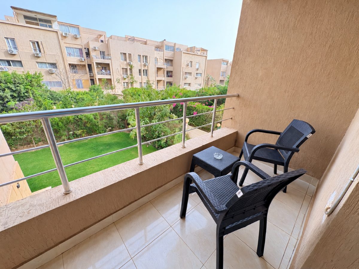 Private balcony with two chairs and a view over the surrounding greenery