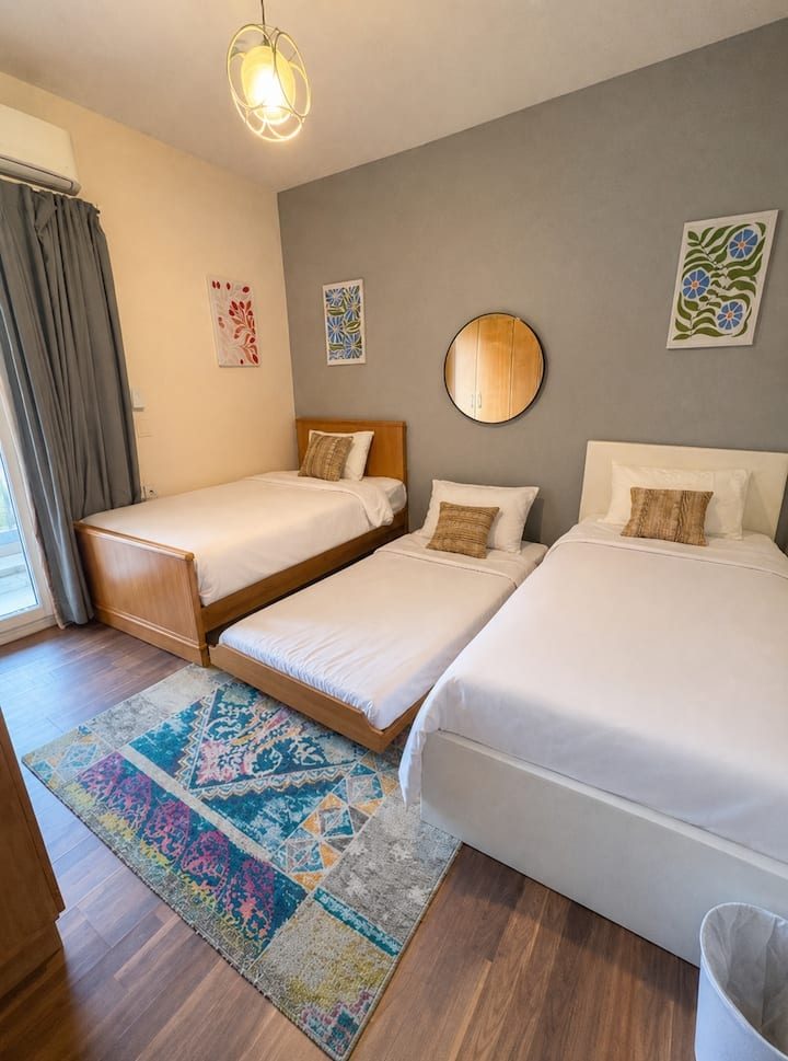 Second bedroom with two single beds and the pull-out third bed made up
