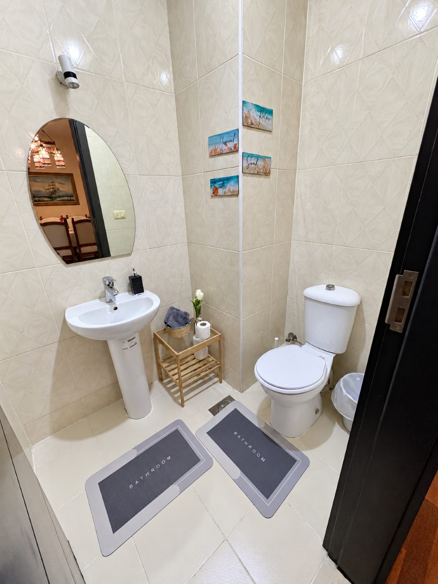 A separate half bathroom with a basin and toilet