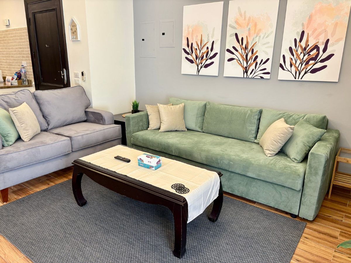 Living-room seating with botanical prints on the wall