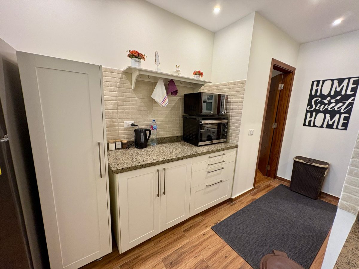 Countertop oven, microwave and kettle on the kitchen counter