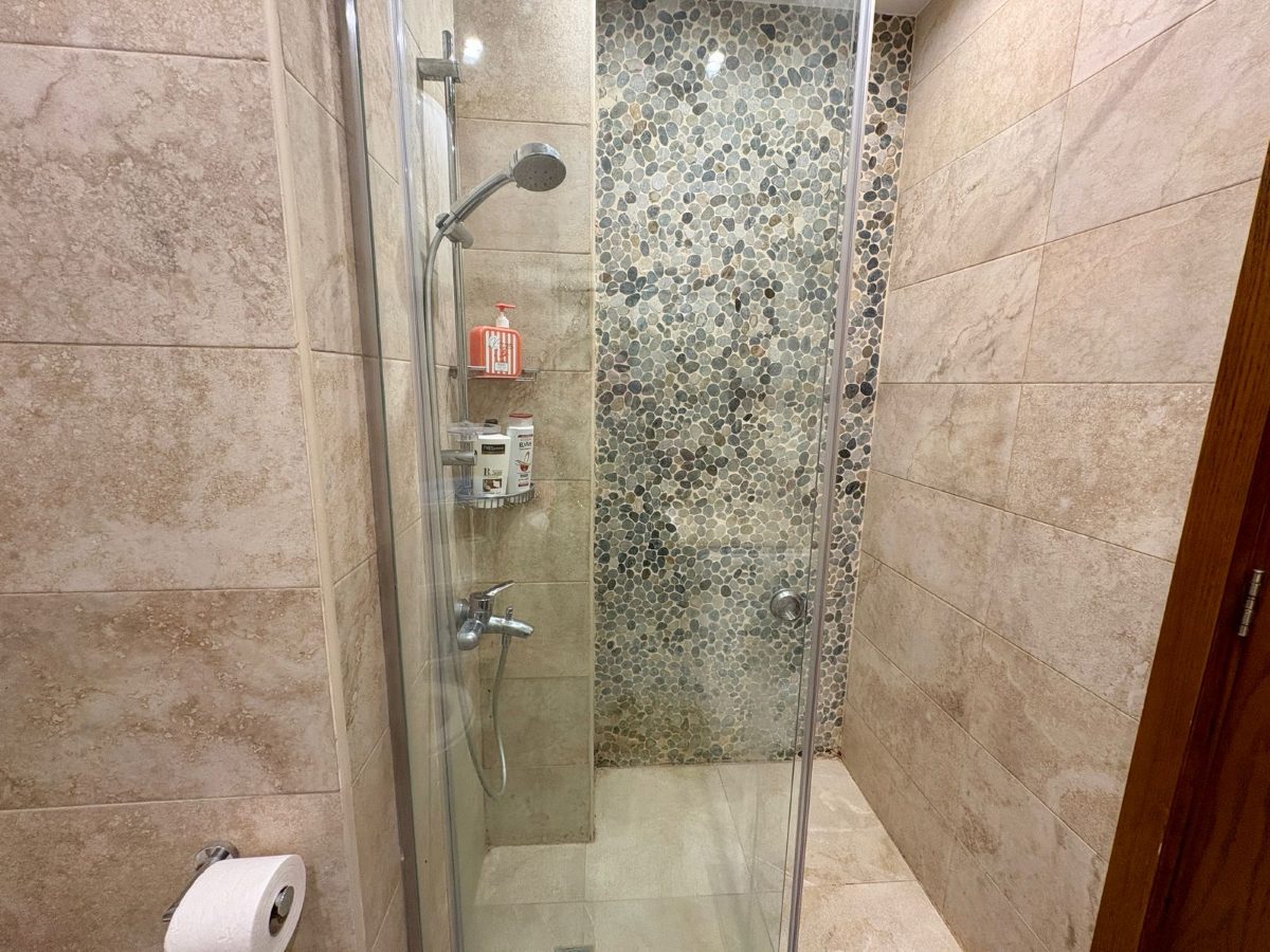 A closer view of the shower and its enclosure