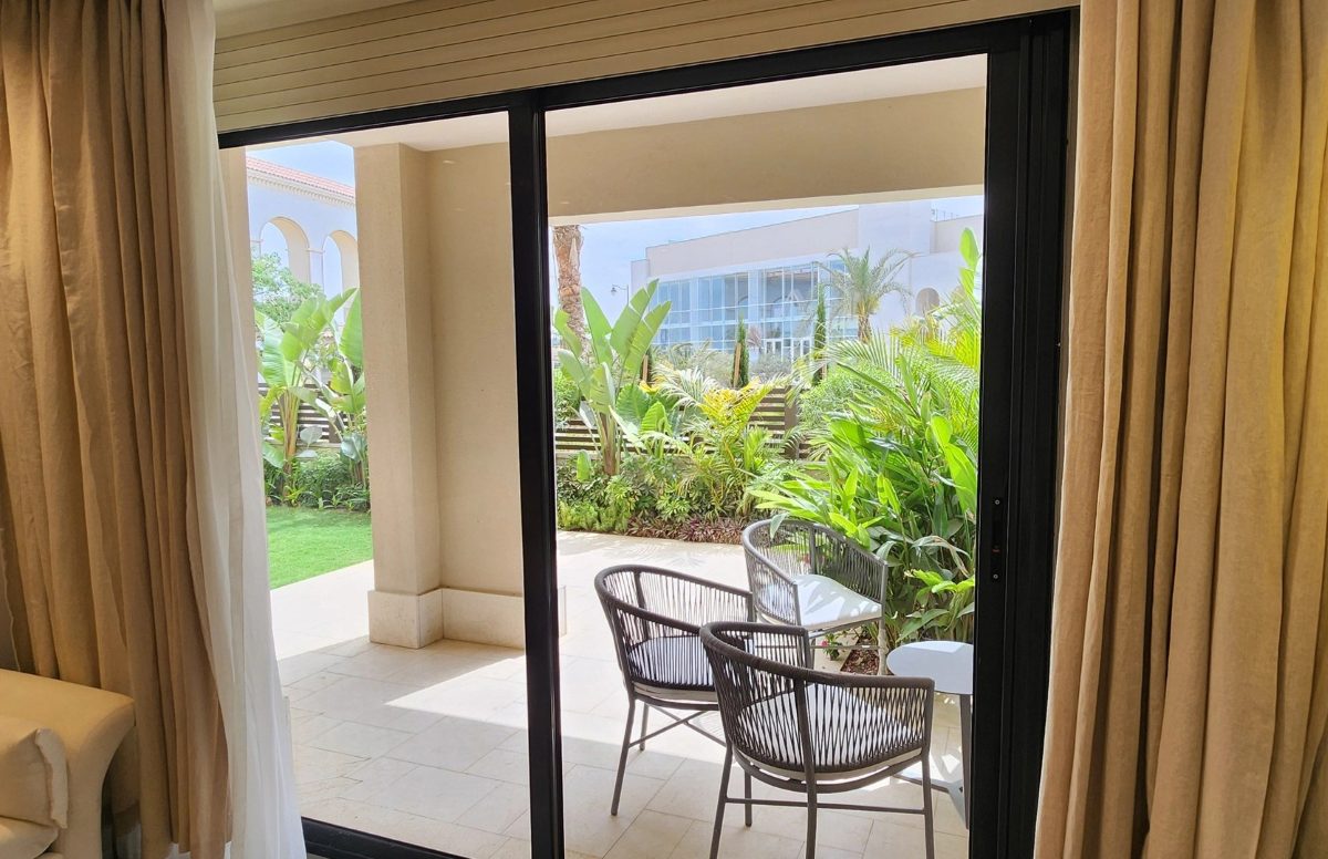 Garden and covered outdoor seating in the compound.