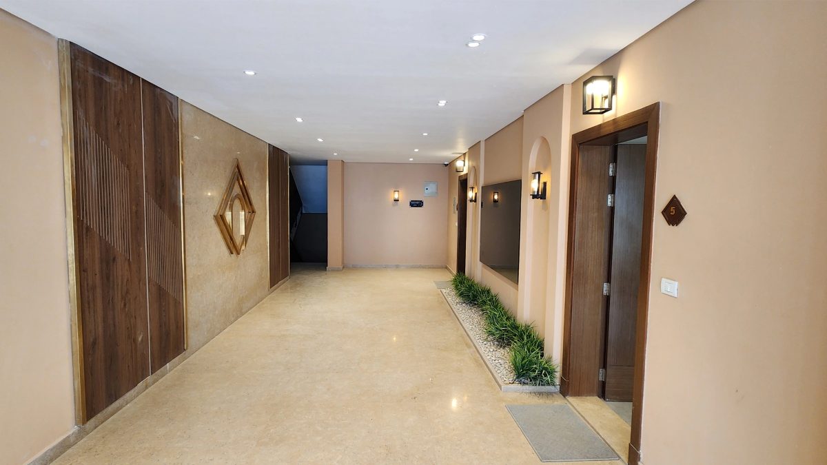 A shared residential hallway within the compound.