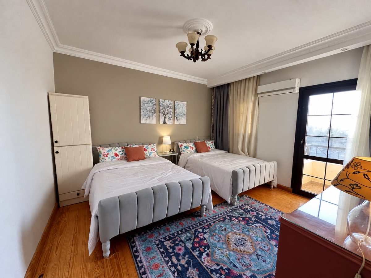 Second bedroom with two double beds and daylight from the window