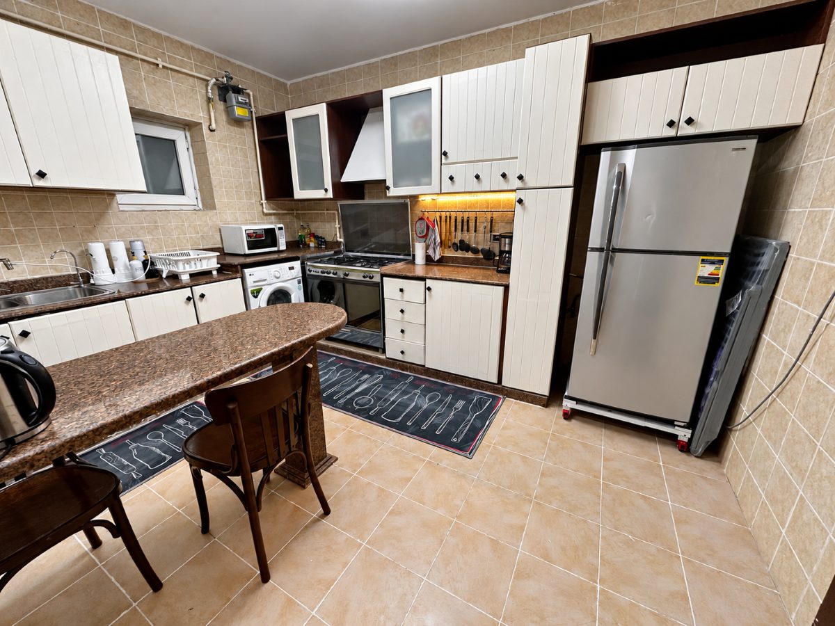 Kitchen with fridge-freezer, oven, hob and washing machine