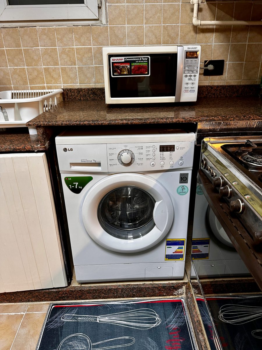 A washing machine is available in the kitchen.