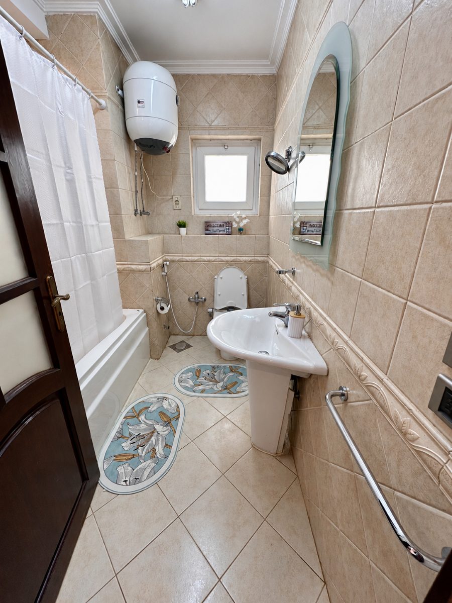 Bathroom with a bathtub and overhead shower