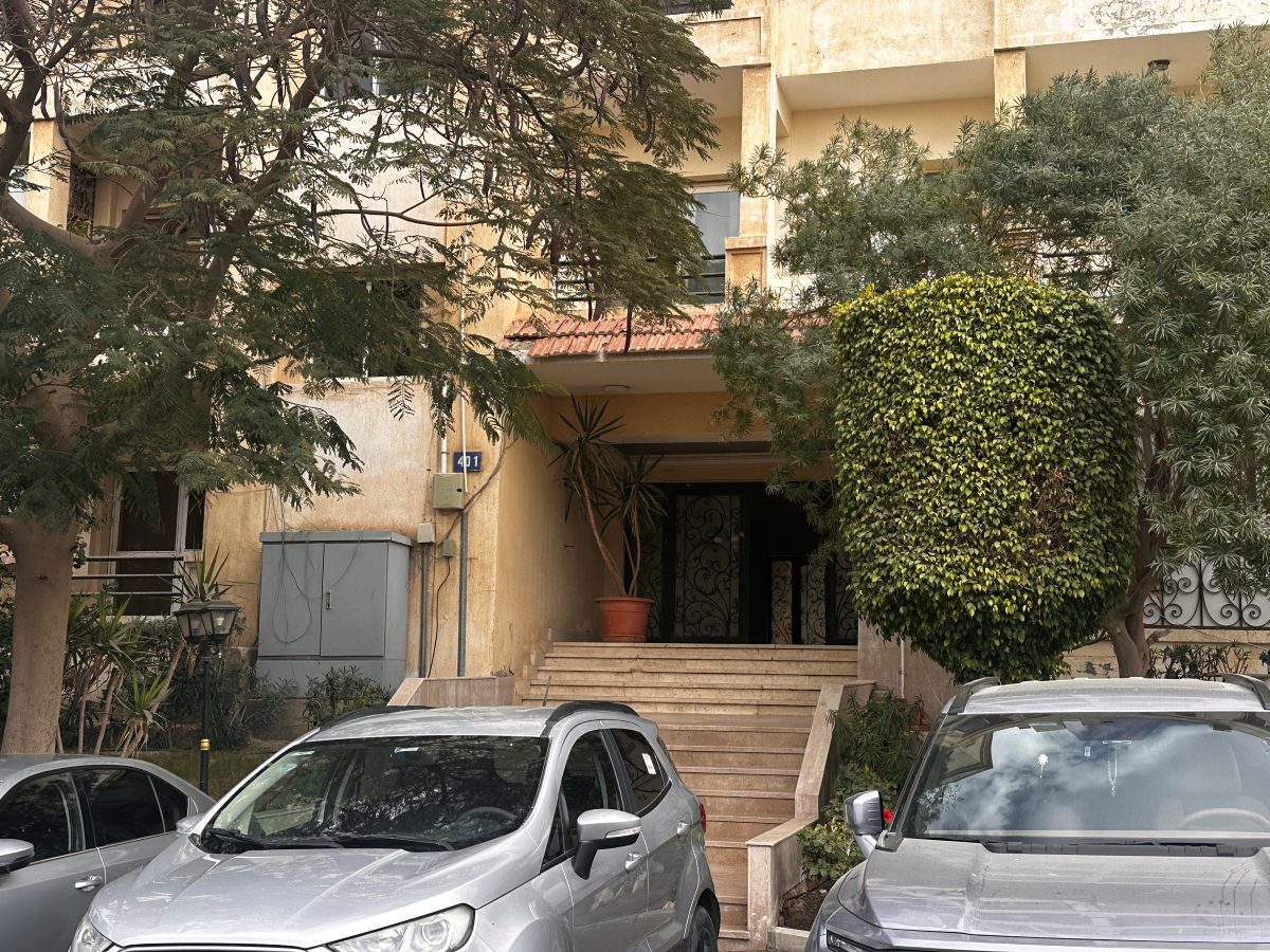 The building entrance with free street parking inside the compound