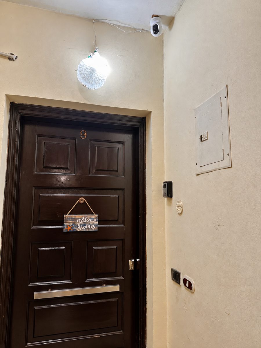 Exterior camera above the front door, facing the shared hallway